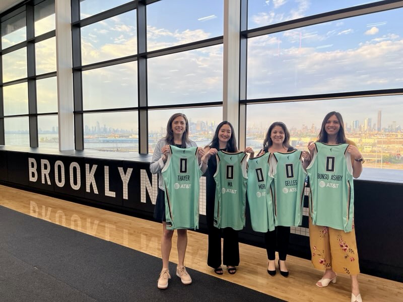 Women in Sports Data founders holding up jerseys in 2022